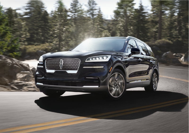 A Lincoln Aviator® SUV is being driven on a winding mountain road | Karl Malone Lincoln in El Dorado AR