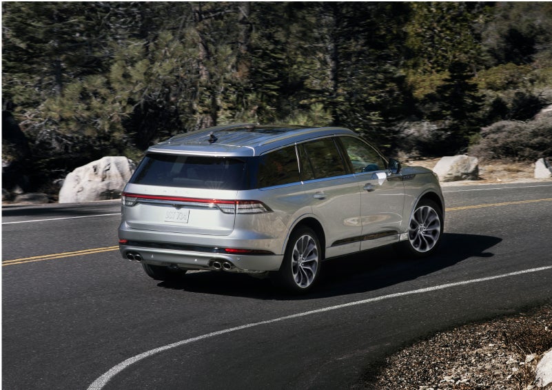 A Lincoln Aviator® is being driven on a winding road | Karl Malone Lincoln in El Dorado AR