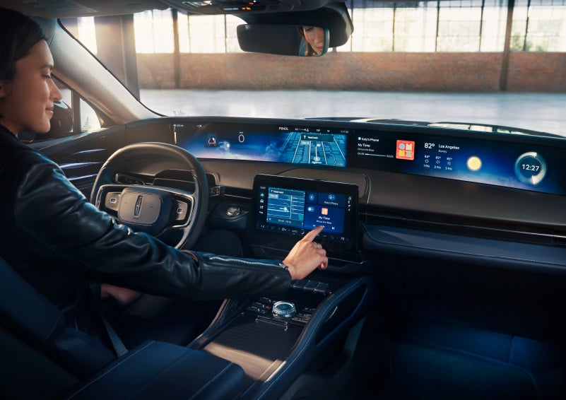 The driver of a 2024 Lincoln Nautilus® SUV interacts with the center touchscreen. | Karl Malone Lincoln in El Dorado AR